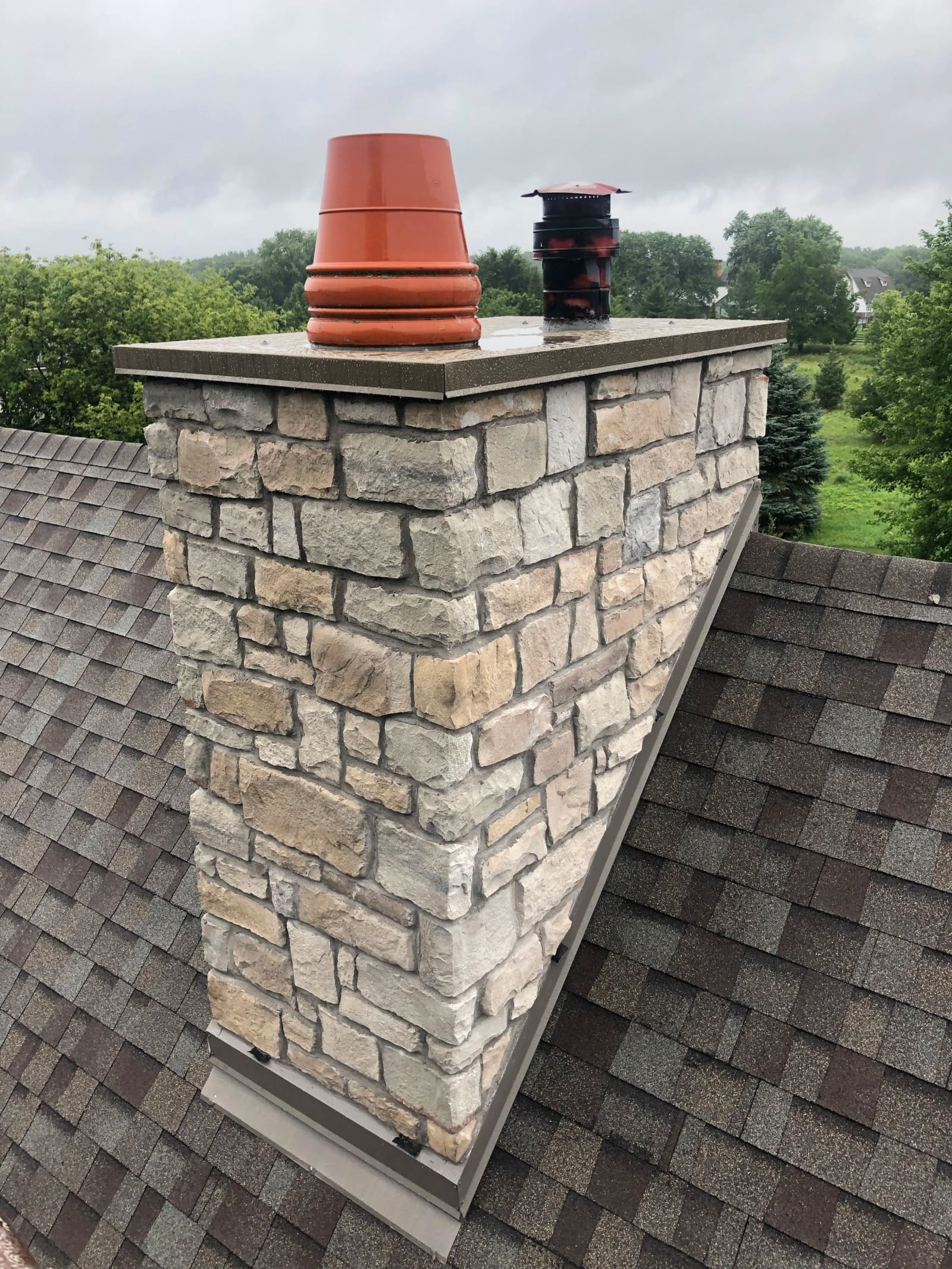 After: Chimney was causing water damage inside the home — rebuilt with correct flashing to stop the leak for good.