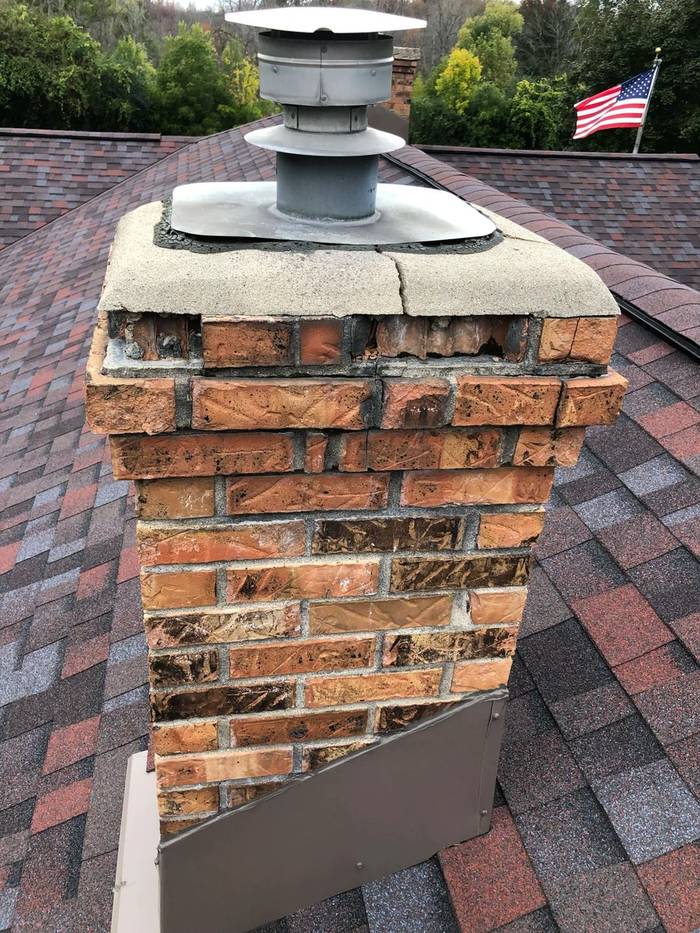 Chimney brick with badly spalling faces and washed-out mortar joints