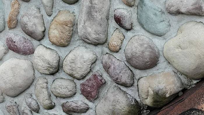 Fieldstone wall with freshly repointed mortar joints, completed by Watertight Masonry